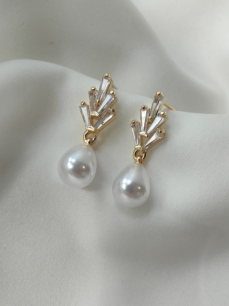 PRE ORDER FOR END JUNE DELIVERY A simple and elegant Art Deco inspired pearl drop earring for the Bride. A dainty teardrop pearl suspended from a fixed 18ct gold plated crystal stud earring. A simple elegant choice to treasure and wear time and time again. Materials 18ct gold plated earring for pierced ears Size Approx 2.8 cm in length x approx .6cm in width. Lightweight Pearl Drop Bridal Earrings, Drop Bridal Earrings, Pearl Drop Earrings Bridal, Crystal Bead Jewelry, Pearl Necklace Designs, Pearl Accessories, Bridal Earrings Drop, Bride Earrings, Bridal Gold Jewellery Designs