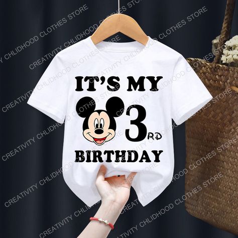 Make their birthday magical with this adorable Mickey Mouse birthday t-shirt! Featuring a classic Mickey Mouse design and their special birthday number (available from 1-9), this shirt is perfect for boys, girls, or any little Disney fan.  This comfy tee is made from soft, breathable fabric for all-day wear. It's a must-have for  and milestone mousefan #toddlerclothes ments #abystyrthdayphaby #comfyclothes #casualwearkidsthemedbirthday Hood Clothes, Bebe T Shirt, Mickey Mouse Design, Disney Birthday, Food Clothes, Mickey Mouse Birthday, Birthday Numbers, Jean Accessories, Jeans Kids