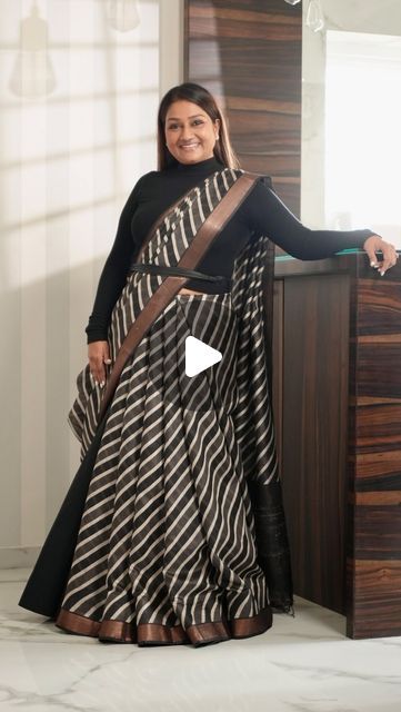 Dolly Jain 🇮🇳 on Instagram: "#SAREELS 425
The reel you’re watching today has a special story behind it. Every reel I create has a message related to a saree, a moment, or an emotion.

About a month ago, I received this saree but due to my constant travel, I didn’t have the chance to open and appreciate it until the day before the shoot. When I finally took a look at it, I instantly fell in love with the fabric and texture. That’s when I decided to try something different with it instead of the usual drape. I opted for a unique D’Coat bell style.

It was a fun experience draping this saree with the D’Coat bell. The first shot in the reel was actually taken without me noticing, as I was completely absorbed in the music playing in the background.

Every saree has its own story to tell, and Saree With Boots Look, Dolly Jain Dupatta Draping, Two Saree Draping Styles, Saree With Dupatta Draping, Saree With Coat, Dolly Jain Saree Draping, Unique Saree Draping, Different Saree Draping Styles, Dupatta Draping Styles