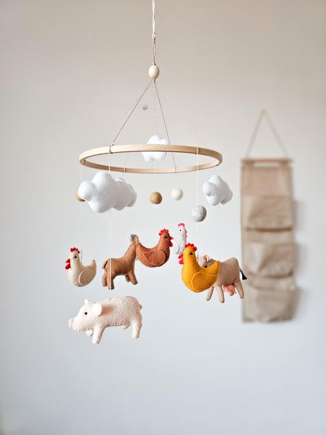 The farm baby mobile brings a charming country farmhouse feel to your little one's nursery. Featuring adorable animals like a cow, goat, chicken, and pig, this delightful mobile is perfect for adding a touch of animal nursery decor to create a cozy and playful environment for your baby. ☑️ BABY MOBILE INCLUDES: - 1 pig - 1 cow - 1 goat - 4 small chickens  - 4 clouds - 3 felt balls ☑️ You can also buy music box ➡️ www.etsy.com/listing/1162035340 💛 If you have any questions about the product, fee Pig Themed Nursery, Chicken Nursery Theme, Farm Nursery Ideas, Farmer Nursery, Baby Farm Animals Nursery, Cow Themed Nursery, Farmhouse Baby Nursery, Farm Animals Nursery Theme, Farm Theme Nursery