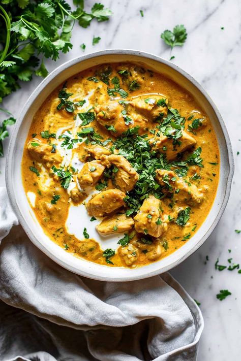 A slow cooker chicken korma is a creamy and mild curry that uses simple pantry ingredients that are available in Aldi, or any other grocery store. Seared golden chicken, slow-cooked in a tangy and fragrant coconut milk yoghurt sauce, this is going to be a family favourite that everyone will love. It's also perfect for freezing so makes a great addition to meal planning. Aldi recipes, dinner, budget recipes. Mild Coconut Curry Chicken, Interesting Crockpot Recipes, Coconut Chicken Korma Recipe, Coconut Chicken Slow Cooker, Slow Cooker Yellow Chicken Curry, Healthy Indian Curry Recipes, Ministry Of Curry Recipes, Chicken Coconut Korma, Crockpot Chicken Korma