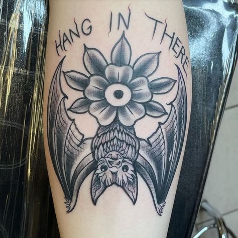 Hang In There Bat Tattoo, Bat Tattoo Under Knee, Halloween Shin Tattoo, Bat Hanging Tattoo, Modern Flash Tattoo, Spooky American Traditional Tattoo, Hang In There Tattoo, Trad Bat Tattoo, American Traditional Bat Tattoo