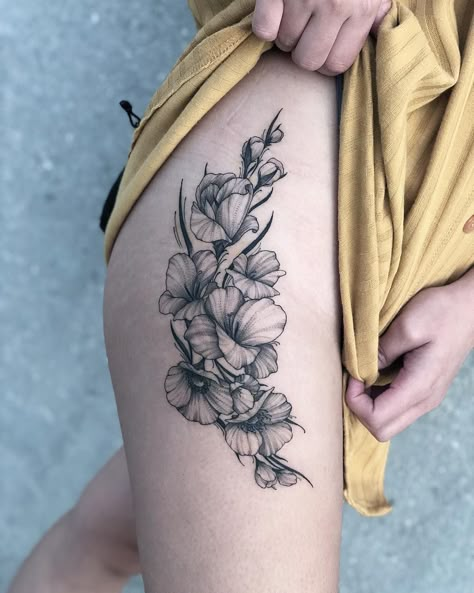 If you've been thinking about getting a tattoo of your zodiac sign, you may want to consider birth flower tattoos while you're at it. Like a birth stone, there Half Sleeve Tattoos Lower Arm, August Birth Flower Tattoo, Gladiolus Flower Tattoos, Birth Flower Tattoo Ideas, Sleeve Wrist Tattoos, Gladiolus Tattoo, Water Lily Tattoos, Pattern Tattoos, August Birth Flower