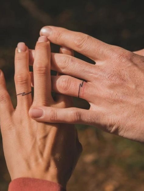 Ditch the Rings: 21+ Badass Wedding Ring Tattoos That Say “Forever" Men’s Tattoo On Ring Finger, Tattooed Wedding Bands, Engagement Ring Tattoos, Men’s Ring Tattoo Designs, Tattooed Wedding Rings, Ring Finger Tattoo Men, Wedding Ring Tattoo Ideas For Women, Ring Tattoo For Men, Marriage Tattoos Ring Finger