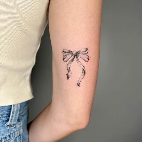 Explore bow tattoo meaning. Discover the symbolic meaning behind bow tattoos and get inspired with our collection of unique bow tattoo designs and bow tattoo ideas. Tattoo Ideas For Girls Arm, Red Ribbon Tattoo Meaning, Bow Back Tattoo, Cute Girl Tattoos Ideas, Ribbon Tattoos Thigh, Lace Ribbon Tattoo, Bow Tattoo Template, Mini Bow Tattoo, Bow Tattoos For Women