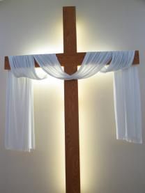 Cross draped with white cloth for Easter. Photo by creativex / iStockphoto.com. Cross Backdrop For Wedding, Cross With Cloth Drape, Cross With White Cloth, Wedding Cross Decor Ceremony Backdrop, Wedding Cross With Drape, Cross Stage Design, Lent Decorations For Church, Jesus Cross Wallpaper, Wood Crosses Diy