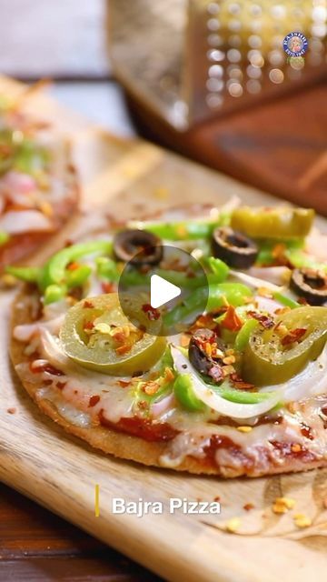 Rajshri Food on Instagram: "One dish that brings the whole family together is none other than Pizza!  Celebrate the international family day with our gluten-free Bajra Pizza! 😍 Recipe by Chef Ruchi Bharani (@chefruchibharani)  Gluten-Free Bajra Pizza Ingredients: To Make Dough For Gluten-Free Pizza Base  Water 1 & 1/2 cup Pearl Millet Flour 2 tbsp Rice Flour Salt To Taste 2 Pinch Baking Powder 1/2 tsp Red Chilli Powder 1 tbsp Oil Warm Water  To Roll The Pizza Base Pearl Millet Flour Parchment Paper  To Cook The Pizza Base  Oil  To Make Gluten-Free Bajra Pizza Pizza Sauce Shredded Onion Green Capsicum Gluten-free Cheese Jalapeno Black Olives Italian Pizza Seasoning Red Chilli Flakes  Oil  #Recipes #Pizza #Glutenfree #foodie #foodstagram #food #recipe #rajshrifood #anybodycancookwithrajshri Gluten Free Pizza Base, Pizza Seasoning, International Family Day, Healthy Vegetarian Snacks, Pearl Millet, Green Capsicum, Pizza Base, Millet Flour, Red Chilli Powder