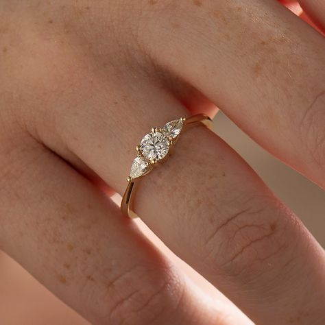 The three-stone round & pears engagement ring, made in 14k or 18k yellow gold and set with clear natural diamonds. This page is for 0.30ct or 0.40ct center diamond. Made in 14k or 18k yellow, rose, or white gold. The images show the ring with a center diamond of 0.40ct. ● You can choose the diamond weight and metal from the menu bar above. This listing is for YELLOW GOLD. You can order other colors from the following links: ● Rose gold - https://www.etsy.com/listing/1082827216/ ● White gold Yellow Gold Diamond Engagement Ring Vintage, Whimsical Gold Engagement Ring, Engagement And Band Set, Engagement Rings Dainty Vintage, Flat Engagement Ring Vintage, Delicate Gold Rings Engagement, Simple Vintage Engagement Rings Gold, Simple Low Set Engagement Rings, Flat Gold Engagement Ring