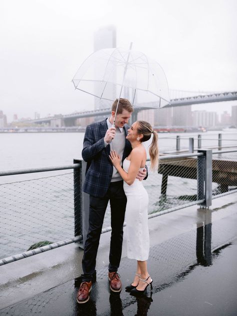 Newly Engaged Couple Taking Photos with clear umbrellas Bridge Proposal, Umbrella Photoshoot, Park Proposal, Proposal Inspiration, Clear Umbrella, Brooklyn Bridge Park, Couple Kissing, Pouring Rain, Engaged Couple