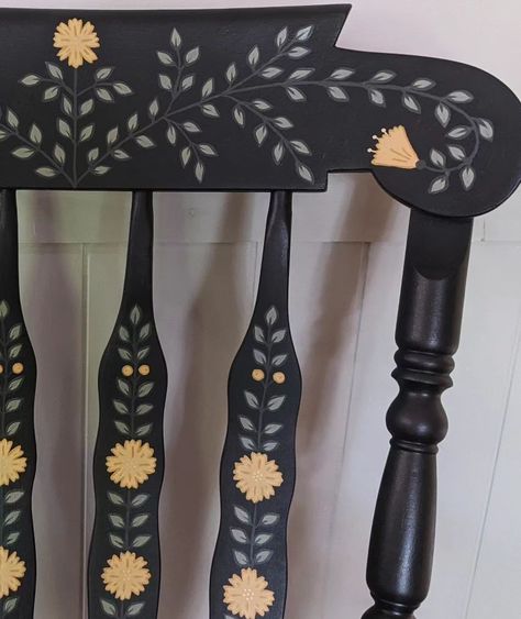 Large, solid wood, and super sturdy rocking chair. This is a repaint of my first rocking chair since I've decided to keep the last wooden one for now! The base color is a charcoal that appears more like dark blue in bright lighting. Lots of hand painted leaves, yellow flowers, and little gold details. 🌼 #handpaintedfurniture #handpaintedchair #handpaintedrockingchair #vintagerockingchair #rockingchair #accentchair #nurserydecor #nurserychair #fusionmineralpaint #colorfulhome #interiordesign ... Wooden Rocking Chair Makeover Ideas, Hand Painted Wooden Chairs, Nordic Painted Furniture, Painted Flower Furniture, Wooden Chair Painting Ideas, Cottagecore Painted Furniture, Folk Art Chair, Hand Painted Home Decor, Painted Wooden Stool