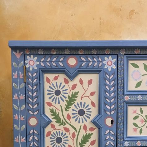 Emma Best on Instagram: "I've been so busy painting recently and getting ready for @suffolkopenstudios next month that I keep forgetting to post! Here is a snippet of a beautiful 94 year old cabinet I've been working on, covered with lovely hand painted folk details 🌿 Painted on my all time favourite blue _ @chalkpaint #greekblue 🩵   Hopefully I'll have a few more pieces to show this week as I try to make the studio a little less 'brown' with all its unpainted pieces! Which me luck! 🍀  #folkart #folkartist #folkartists #modernfolkart #folk #anniesloanchalkpaint #emmabestdesign #suffolkart #suffolkartist #suffolkartists #folkfurniture #handpainted #suffolkopenstudios" Paint Designs On Furniture, Scandinavian Folk Furniture, Folk Room Decor, Hand Painted Cupboard Doors, Scandinavian Folk Art Door, Folk Art Wardrobe, Folkart Painted Furniture, Hand Painted Floral Furniture, Nordic Painted Furniture