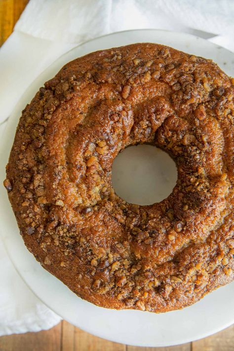 Walnut Bundt Cake top-down view on cake stand Coffee Walnut Bundt Cake, Apple Walnut Bundt Cake Recipes, Easy Walnut Cake, Walnut Baking Recipes, Eggless Dates And Walnut Cake, Walnut Bundt Cake Recipes, Desserts With Walnuts Baking, Banana Walnut Bundt Cake, Recipes Using Walnuts Baking