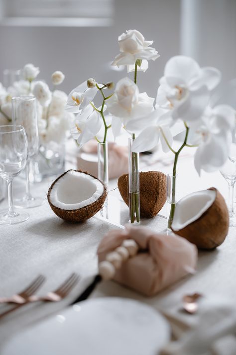 Stunning White Wedding Decor with Orchids and Coconuts Coconut Centerpiece Wedding, Coconut Wedding Decoration, Coconut Wedding Table Decor, Orchids At Wedding, Coconut Table Setting, Wedding Orchids Decoration, Orchid Flower Wedding Decoration, Coconut Table Decor, Wedding Photos On The Beach