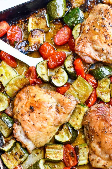 In this delicious summery sheet pan dinner chicken thighs are seasoned with garlic and herbs and roasted with tender chunks of zucchini and cherry tomatoes that caramelize as they cook. The fresh basil sprinkled on just before serving enhances the summer tastes. This meal is gluten free, paleo and incredibly simple. Dinner Chicken Thighs, Chicken With Zucchini, Dinners Chicken, Zucchini And Tomatoes, Noom Recipes, Chicken Tomatoes, Cherry Tomato Recipes, Zucchini Tomato, Dinners Recipes