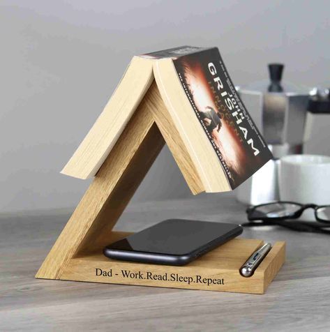 Celebrate Father's Day with a personalised solid oak bookstand, the perfect gift for bookworms! 📚 Our bedside bookrest and bookmark combo is a dream come true for any book lover. Engraved with your thoughtful or funny message, it’s a gift that’s as unique as he is. ✨ Wooden Anniversary Gift, Book Rest, Personalized Desk, Book Stand, Reading Gifts, Wooden Books, Diy Holz, Book Holders, Wooden Projects