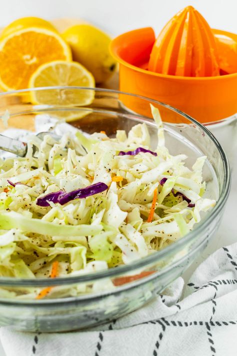 This Sweet Citrus Slaw has been a family favorite for years. It’s a deliciously crisp, tangy and lightly sweet mix of green cabbage, red cabbage, and carrots topped with a mixture of orange juice, lime juice, lemon juice, and maple syrup. #citrusslaw #citruscoleslaw #slaw #slawrecipe #sweetslaw #dinner #sidedish #coleslawrecipe Citrus Slaw, Citrus Slaw Recipes, Citrus Coleslaw, Citrus Coleslaw Recipe, Carrot Apple Slaw Recipes, Clow Slaw, Cilantro Lime Cabbage Slaw, Red Cabbage Citrus Slaw, Carrot Slaw