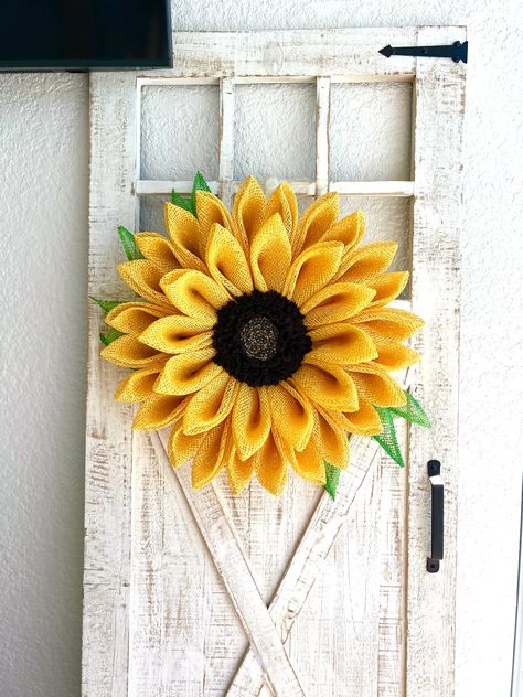 A summertime sunflower wreath for your front door, a Mother’s Day gift, a cheerful cemetery marker. My wreaths are one of a kind and constructed thoughtfully and securely. You will not be disappointed and this flower will look stunning to all who see it.This sunflower wreath measures approximately 23” across x 20” up and down x 5” deep and is constructed on a wire wreath base with a hand-made center, poly burlap mesh, plastic canvas mesh, chenille stems, zip ties, hot glue and a beautiful backin Sunflower Wreaths For Front Door, Lanai Decor, Sunflower Wreath Diy, Tropical Wreath, Sunflower Crafts, Candy Wreath, Mothers Day Wreath, Beach Wreath, Wreath Base