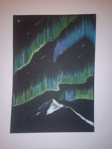 Black paper with a shadow of a snowy mountain peak light one side darker on the other. Lights blended in the sky I bright green blues and purple. Stars and shooting stars in white. Chalk Northern Lights, Chalk Pastel Northern Lights, Northern Lights Chalk Art, Chalk Christmas Lights, Northern Lights Oil Pastels, Oil Pastel Art Christmas, Chalk Drawings On Paper, Northern Lights Drawing, Northern Lights Art Project