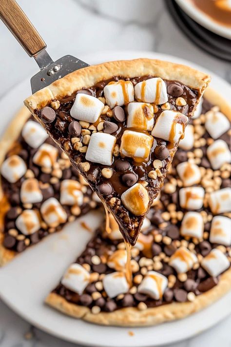 This indulgent s'mores pizza is loaded with chocolate, Nutella, gooey marshmallows, graham crackers, and nuts, making it the ultimate dessert treat! Dessert Pizza Recipe, Sticky Dates, Dessert Pizza Fruit, Pizza Fruit, Nutella Pizza, Dessert Pizza Recipes, Smores Dessert, Chocolate Pizza, Super Easy Desserts