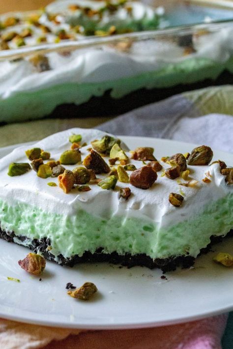 No Bake Pistachio Pudding Dessert is the perfect easy no bake layered dessert to end any meal. Made using Jell-O Pistachio Instant Pudding, chocolate sandwich cookies and whipped topping, this No Bake Pistachio Pudding Dessert is always a family favorite recipe! | A Wicked Whisk #nobakepistachiopuddingdessert #pistachiodessert #pistachiopuddingdessert #pistachiodessertpuddingwhippedtopping #jellopistachiopuddingpie #nobakepistachiopuddingpie Pistachio Oreo Dessert, Instant Pistachio Pudding Recipes, Pistachio Pudding Dessert, Pistachio Recipes Desserts, Work Desserts, Pistachio Dessert Pudding, Pistachio Pudding Cookies, Pudding Desserts Recipes, Pistachio Dessert