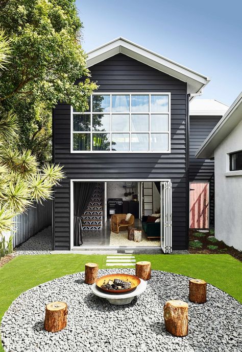 The white window trims and roof contrast beautifully against the dark exterior of this home. Dark Home Exterior, Dark House Exterior, New York Loft, Out Magazine, Dark House, Exterior Color Schemes, Dark Home, Casa Exterior, White Windows