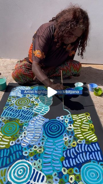 Pwerle Aboriginal Art Gallery on Instagram: "Dora Mbitjana, an Anmatyerre woman hailing from Central Australia, embodies a rich cultural legacy rooted in her ancestral lands. Born in 1965 to the renowned Minnie Pwerle and Motorcar Jim, with siblings including the late Barbara Weir and the late Betty Mbitjana, Dora carries forward a tradition steeped in artistic excellence.

Her artistic journey is a tribute to her mother’s legacy and the deep connection to Atnwengerrp, the ancestral homeland nestled in the northern reaches of the remote Utopia region. Through her vibrant paintings, Dora intricately weaves the stories and essence of Atnwengerrp, where concentric circles symbolise waterholes and small circles represent the sacred anemangkerr—a bush melon or tomato revered for its significanc Central Australia, Artistic Landscape, Vibrant Paintings, Concentric Circles, Deep Connection, The Collective, Aboriginal Art, Cultural Heritage, Paint Designs