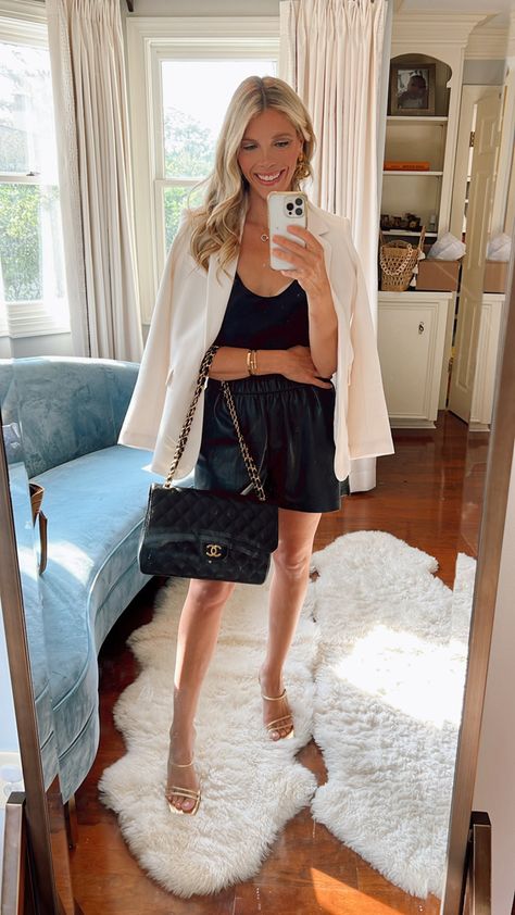 Woman in black leather shorts, black camisole, cream blazer, gold heel shoes Black Silk Shorts Outfit, Short Black Silk Skirt Outfit, Chic Black Club Shorts, Elegant Black Shorts For Date Night, Silk Shorts Outfit, Luxury Silk Chic Shorts, Chic Date Night Outfit, Black Silk Camisole, Styling Clothes