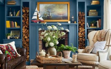 a living room with a fireplace and mantel Wood Fireplace Surrounds, Best Blue Paint Colors, Colonial Blue, Library Living Room, Brown Rooms, Colonial Style Homes, Country Living Magazine, Blue Paint Colors, Room Paint Colors