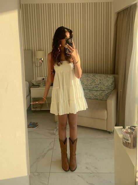 Non Country Cowboy Boot Outfit, Straw Hat And Dress Outfit, White Flowy Dress With Cowgirl Boots, Sundress Cowgirl Boots, Women’s Western Boots Outfits, Cute Stagecoach Outfits, Skirt As A Top Outfit, Taylor Swift White Dress Cowboy Boots, Sundress Cowboy Boots Summer Outfits