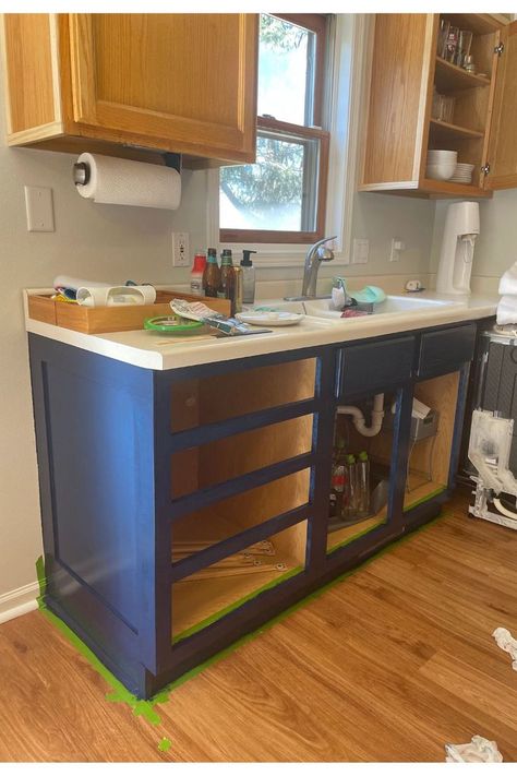 In progress pictures painting the lower cabinets navy. The drawers and cabinet doors are removed. Navy And White Kitchen Cabinets, Navy Blue And White Kitchen, White Kitchen Cabinet Design, Navy And White Kitchen, Blue And White Kitchen Cabinets, White Cottage Kitchen, Navy Kitchen Cabinets, Navy Blue Kitchen Cabinets, White Kitchen Cabinet