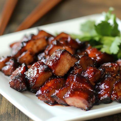 Char Siu is a Cantonese-style BBQ pork dish that has roots in ancient China. The name "Char Siu" literally means "fork roast," referring to the traditional method of skewering strips of marinated pork with long forks and roasting them over an open fire. The dish became iconic in Cantonese cuisine and is characterized by its bright red color, which originally came from the use of red fermented bean curd.  #CharSiu #ChineseBBQ #PorkLovers #AsianCuisine #EasyDinner #GrilledGoodness #BBQPork Cantonese Cuisine, Char Siu, Marinated Pork, Open Fire, Bean Curd, Bbq Pork, Pork Dishes, Ancient China, Skewers