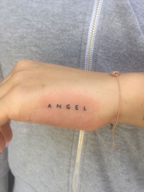 Angel Words Tattoo, Tattoo Between Boop Simple, Angel Tattoo Letters, Mini Love Tattoo, Mini Angel Tattoo, Angel Tattoo Writing, Angel Lettering Tattoo, Angel Writing Tattoo, My Angel Tattoo