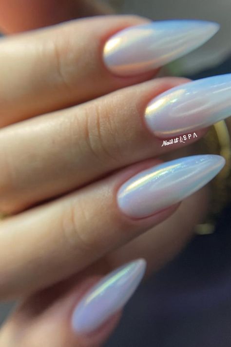 These almond-shaped nails are simply mesmerizing with their opalescent finish that catches the light with a holographic effect. The sheer and subtle luminosity offers an understated yet chic look perfect for any occasion. They're a dreamy twist to a minimalist manicure, reflecting an ethereal rainbow sheen that’s both modern and sophisticated. ✨  // Photo Credit: Instagram @nail.it.spa Iridescent Nails Almond Shape, Nail Ideas Iridescent, Galaxy Almond Nails, Opalite Nails, Opal Almond Nails, Neutral Nails With Chrome, Subtle Rainbow Nails, Opal Chrome Nails, Irredecent Nail Designs