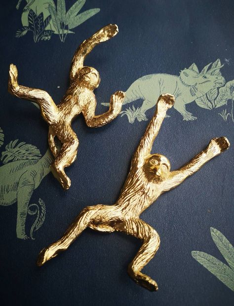 If you love quirky design and want something truly different for your decor then these golden leaping monkey handles are for you!! Each handle comes in a choice of two super detailed designs. They look excellent in pairs set at different angles. A great choice for children's nursery furniture or for rooms with a tropical or rainforest theme.  Each handle is made from solid brass and has a beautiful warm lustre. These are well made items that are heavy in weight. They fix directly into your furniture via one central fixing.  Suitable for most furniture including high use cabinets. Can be used on bedroom, kitchen, drinks, medicine, curiosity cabinets or bathroom cabinets. Guaranteed to get you lots of positive compliments.  Each cheeky monkey is detailed on both sides.  MEASUREMENTS; Length Gold Nursery Decor, Monkey Decorations, Rainforest Theme, Unique Knobs, Brass Monkey, Brass Animals, Gold Furniture, Brass Furniture, Monkey Design