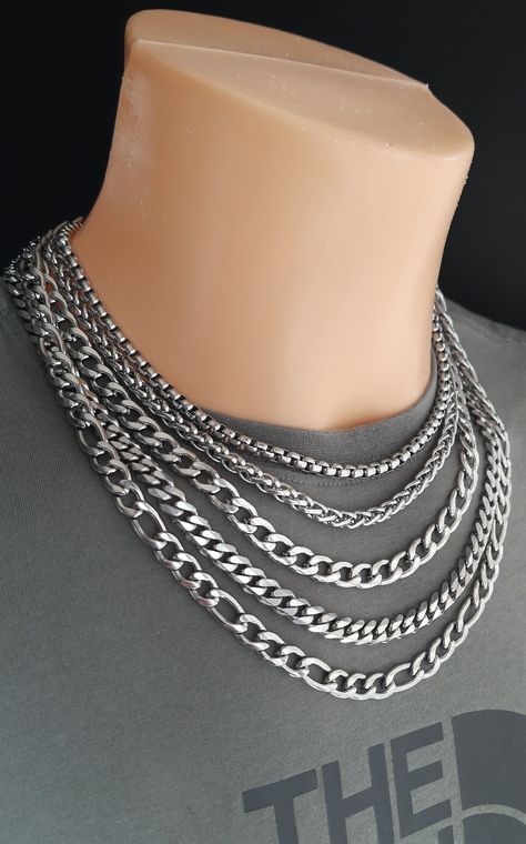 Chain necklace selection featuring the most popular mens thick chains. Strong stainless steel curb, miami, wheat, box and figaro chains. Great casual streetwear fashion accessories for daily wear. #menschainnecklaces #thickchainnecklaces #stainlesssteelnecklaces #miamilinkchain #silvercurbchain #snowstarpendants Figaro Chain Link Jewelry For Streetwear, Thick Chain Necklace Men, Cheap Men's Jewelry With Figaro Chain, Mens Figaro Chain, Cuban Link Rope Chain Necklace For Streetwear, Mens Chains, Necklaces For Men, Stainless Steel Chain Necklace, Metal Fashion