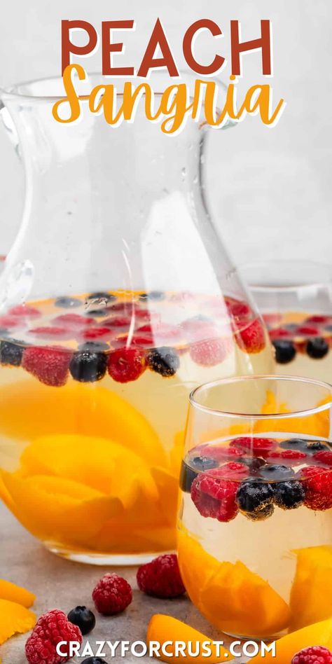 Peach Sangria is an easy party punch recipe full of peach flavor - use frozen fruit to keep the sangria cold! Sangria With Rum, Sangria Recipes With Rum, Easy White Sangria Recipe, Strawberry Peach Sangria, Peach Sangria Recipe, Peach Sangria Recipes, Party Punch Recipe, Sangria Punch, Summer Sangria Recipes