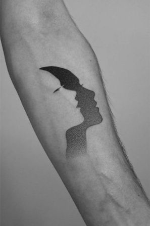 Shadow Negative Space Tattoo. A negative space tattoo with a dotted face design. Click through for 19 negative space tattoo ideas. #negativespacetattoo #negativespacetattooideas #tattooideas #tattoos IG: @pawelindulski Sticker Sketch, Contemporary Tattoo, Negative Space Tattoo, Minimalist Tattoo Meaning, Shadow Tattoo, Typography Tattoo, Tattoo Dotwork, Dotwork Tattoo, Gemini Tattoo