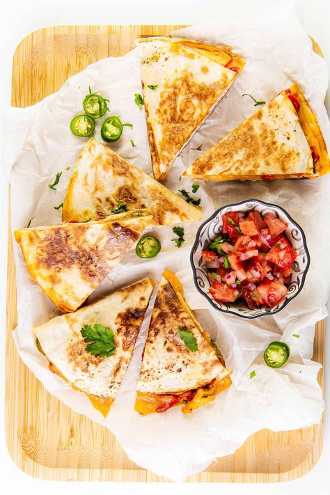 Quesadillas make a fast, simple, and tasty meal! I like to fill mine with chicken, cheese, and veggies, but you can easily customize this recipe with your favorite ingredients. Chicken And Cheese Quesadillas, Roasted Onions And Peppers, Cheese Quesadilla Recipe, Cheese Quesadillas, Chicken And Cheese, British Desserts, Pre Cooked Chicken, Cheese Quesadilla, Chicken With Olives