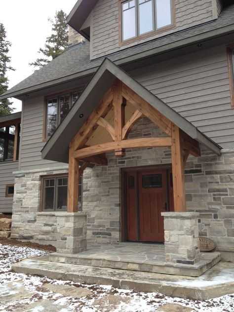 Timber Frame Accent Entryway #TimberFrame #Log #Custom #Accent #Entryway #DiscoveryDreamHomes Front Porch With Timbers, Timber Frame Entrance, Arched Portico, Robin House, Colonial Facade, Stone Entryway, Timber Frame Porch, Pnw Style, Timber Frame Design