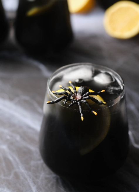 This Black Widow Cocktail is a simple Halloween inspired beverage that gets it's dark hue from black vodka. It's light and refreshing, with a hint of lemon. With only three ingredients, and a few minutes, you'll have a spooky drink for the season! Black Vodka Drinks, Black Widow Cocktail, Black Vodka, Halloween Themed Drinks, Cocktail Halloween, Maleficent Halloween, Halloween Shots, Halloween Party Drinks, Halloween Drinks Alcohol