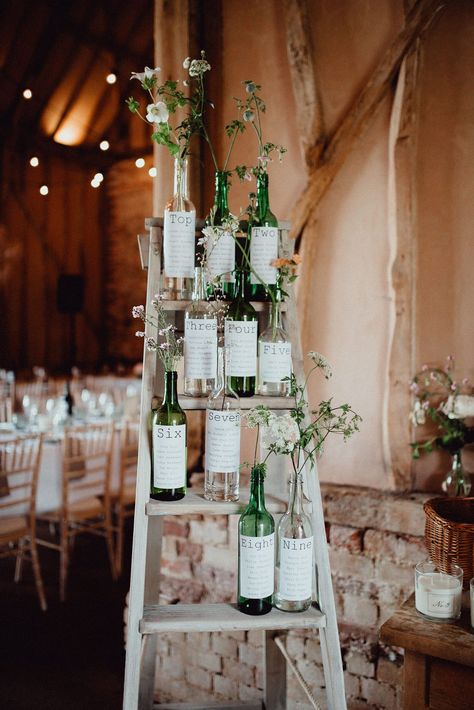 Wine Bottle wedding table plan filled with fresh garden flowers. Images by Emily & Steve. #weddingtableplan #weddingideas #weddingplanning #weddingdetails Wine Bottle Wedding Centerpieces, Wedding Wine Bottles, Flowers In Her Hair, Wedding Bottles, Wedding Table Plan, Seating Plan Wedding, Wedding Table Decorations, Botanical Wedding, Seating Chart Wedding