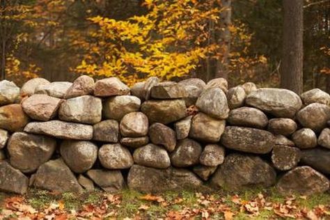 Steep slopes and small cliffs of dirt on your property often erode under excessive rainfall, leaving mud and rock on paths, lawns and driveways. Building retaining walls prevents... Rock Wall Landscape, Stone Wall Backdrop, Rock Wall Gardens, Building A Stone Wall, Boulder Rock, Rock Retaining Wall, Landscape Planning, Building A Retaining Wall, Stone Fence