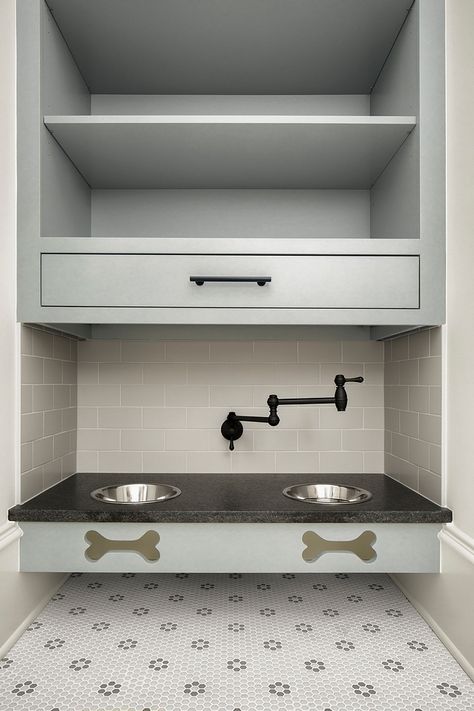 A built-in dog feeding station with pot filler for easy water refilling. This above drawer and shelving also functions as great pet storage, so you can keep all your dogs stuff in one easy to access and remember spot. This cabinetry was custom made and a granite slab was used for the top #mudroom #petfeedingstation #pets #petstation Dog Station, Modern English Country, Transitional Laundry Room, Dog Feeding Station, Grey Shelves, Country House Design, Cabinet Paint Colors, Property Design, Feeding Station