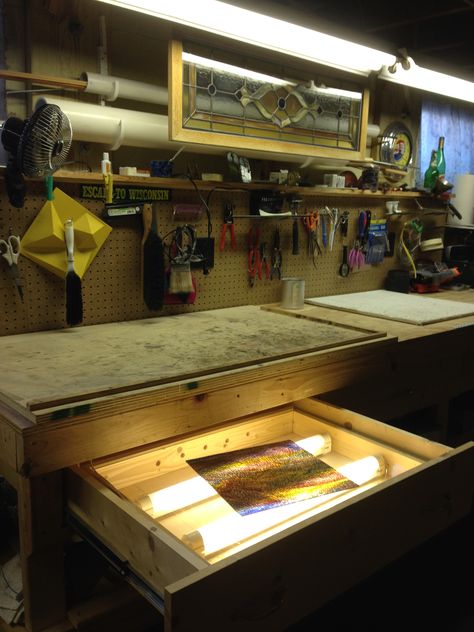 ~The "Glass Dungeon" ~ Stained glass workbench with pegboard tool storage and light table built into a drawer. Large PVC tubes work great for storing lead came and pieces of zinc. Glass Work Table, Pegboard Tool Storage, Garage Organization Storage, Workbench With Pegboard, Stained Glass Cabinets, Stained Glass Studio, Paint White, Mosaic Stained, Led Rope