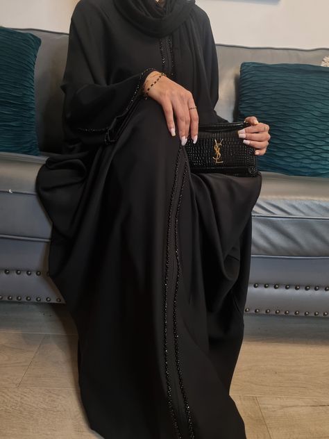 Elevate your style with our Butterfly Abaya Collection  Introducing our new Elegant Jamila Butterfly Abaya, a perfect blend of style and comfort!: Khaki, Dusty Blue, Brown, Dark Brown and Black. This elegant piece features a thoughtful design with the added convenience of an inner belt, allowing for adjustable waist fitting. Made in UAE Hand Wash  Model's Details Our model, a UK size 8 with a height of 5.6, gracefully wears a size 56, showcasing the flattering fit and versatility of this Butterf Khaleeji Aesthetic Black Abaya, Black Abaya Outfit Ideas, Black Abaya Aesthetic, Black Abaya Outfit, Abaya Wardrobe, Elegant Hijab Outfit, Abaya Fashion Black, Abaya Girl, Abaya Shop