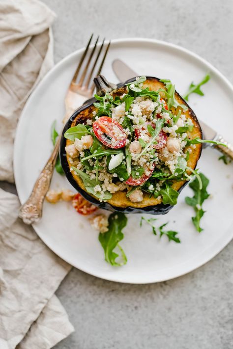 Stuffed Acorn Squash make for an easy and hearty vegetarian main course! Roasted acorn squash halves are filled with a simple mediterranean quinoa salad packed with arugula, chickpeas, scallions, tomatoes, and tangy feta. #StuffedAcornSquash #VegetarianRecipes #RoastedVegetables #ABeautifulPlate Vegetarian Quinoa Salad, Acorn Squash Roasted, Mediterranean Quinoa, Roasted Acorn Squash, Homemade Tahini, Stuffed Acorn Squash, Vegetarian Main Course, Vegetarian Quinoa, Mediterranean Quinoa Salad