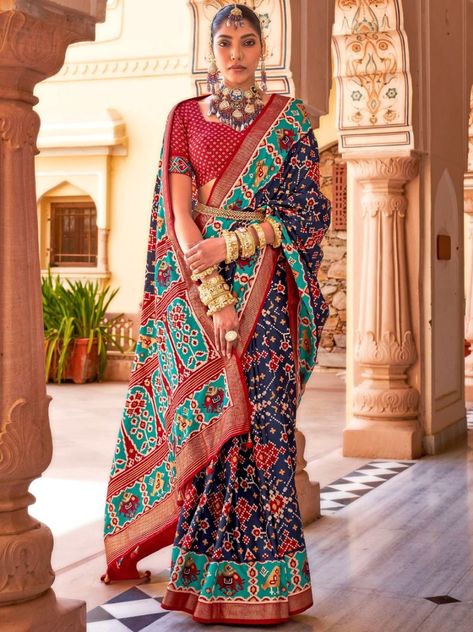 Discover the epitome of elegance with our Navy Blue Patola Saree! Crafted with the finest Mercerized Aircel Silk, this saree is a perfect blend of tradition and class. From weddings to festivals, this saree is designed to make a statement and leave a lasting impression. The rich navy hue of the 5.5-meter long saree is aesthetically complemented by golden prints throughout, adding a touch of opulence and sophistication. The intricate detailing showcases expert craftsmanship, ensuring that every s Blue Patola Saree, Silk Saree For Wedding, Saree For Wedding, Patola Silk Saree, Classic Saree, Patola Saree, Maroon Blouse, Salwar Dress, Navy Blue Print