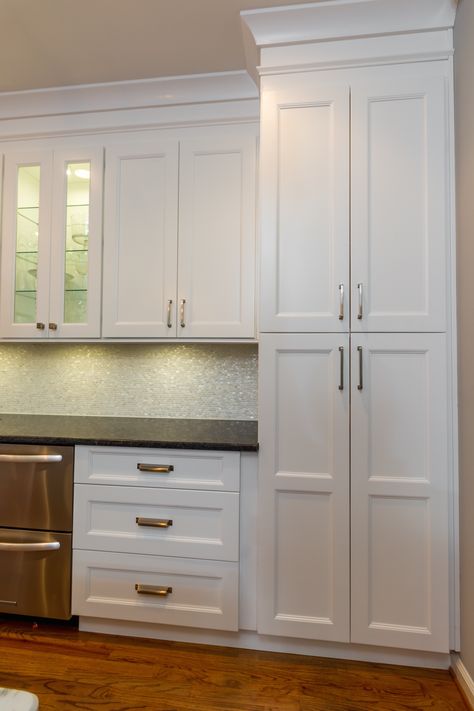 White shaker pantry cabinets. Diy Shaker Pantry Cabinet, Soffit Cabinets, Kitch Cabinet, Partial Overlay Shaker Cabinets, Shaker Pantry Cabinet, White Raised Panel Kitchen Cabinets With Black Hardware, Shaker Style Cabinets With Bevel, Faux Pantry, Types Of Shaker Cabinet Doors