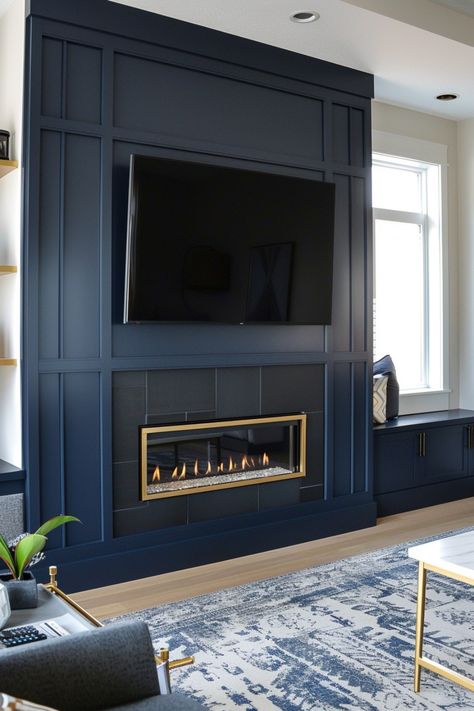 Revamp your living space with stylish fireplace wall designs featuring a wall-mounted TV. Check out more ideas in this article. Blue Wall Fireplace, Basement Tv Wall With Electric Fireplace, Tv Accent Wall With Fireplace, Horizontal Fireplace With Tv Above, Navy Fireplace Wall, Basement Electric Fireplace, Living Room Accent Wall Ideas With Tv, Home Den Ideas, Built In Fireplace And Tv