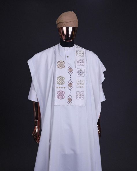 A white, connected square & renaissance maze embrodery details agbada, mixed Swarovski buttons on 3/4 sleeve kaftan & sokoto

What you get:

Agbada
Kaftan men’s top
Pant trousers

Price - available on website

To order:

iMessage, Text or WhatsApp : +2348179435662
+2239179435663
Email: info@dejiandkola.com
Website: dejiandkola.com White Agbada Styles Men, Agbada Styles Men Wedding, White Agbada Designs, Agbada Styles Men, White Agbada, Imessage Text, Muslim Wedding Gown, Agbada Design, Kaftan Designs